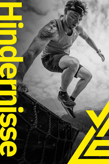 Zu den Hindernissen Teilnehmer überkommt das Hindernis Doppelmoppel - eine steile Holzrampe die ungefähr 2 Meter hoch ist. Arlberger Wadlbeisser Logo als Designelement in gelb am rechten Bildrand. Schriftzug "Hindernisse" vertikal am linken Bildrand. Bild in schwarz und weiß.